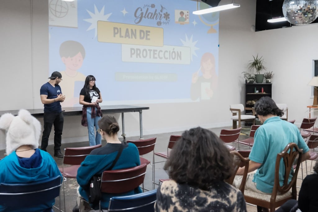 Community organizers Shab and J.T. speak to an audience about immigrant's rights during an event in Atlanta hosted by the Georgia Latino Alliance for Human Rights and the People's Campaign to Stop Cop City on Wednesday, Nov. 18, 2024. (John Arthur Brown)