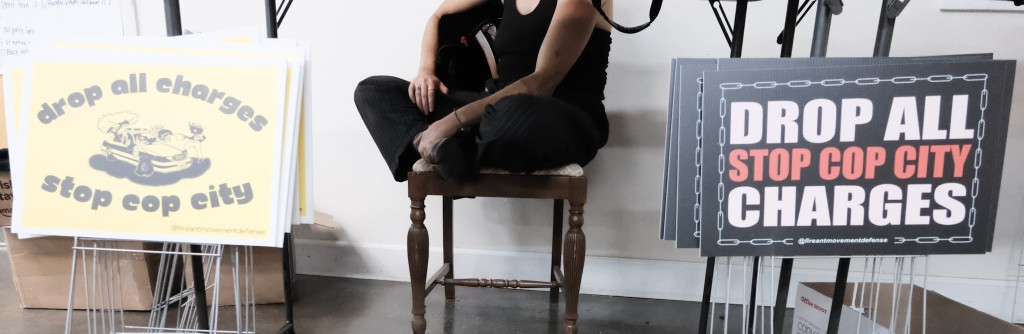 Yard signs calling for charges against alleged Stop Cop City Protesters await distribution at the Imaginary Crimes Tour stop in Atlanta on April 4.