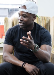 Sherman Neal, a member of the Stone Mountain Action Coalition sits in an upholstered arm chair in a bookstore, discussing Stone Mountain's confederate legacy and the impact on its predominately Black population.