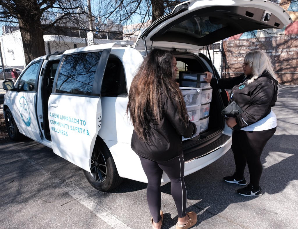 PAD Community Response Team members Erica(left) and Lola(right) prepare a vehicle with necessary supplies such as snack bags, clothing, and care products.