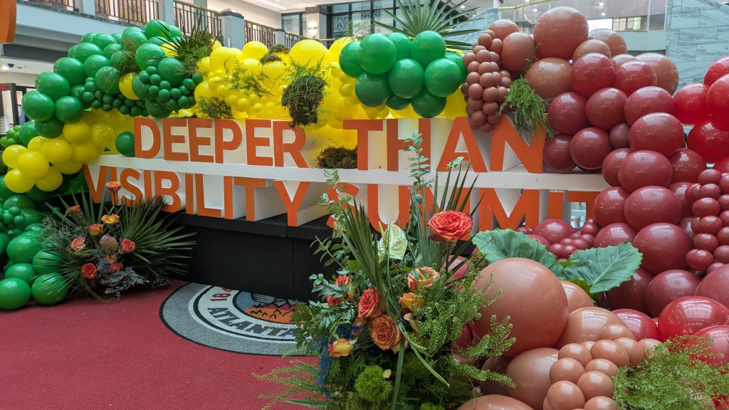 The Deeper Than Visibility Summit sign inside Atlanta City Hall marks the city's celebration of Trans Day of Visibility. 