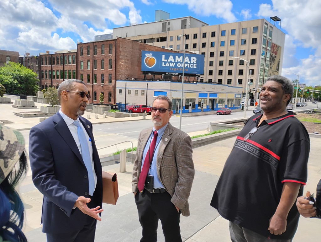 Deputy DA Brian Hawkins talks with Jimmy Hill about developments following the May 5 hearing regarding the police killing of Hill's son, Jimmy Atchison, by former Atlanta Police Department Officer Sung Kim.