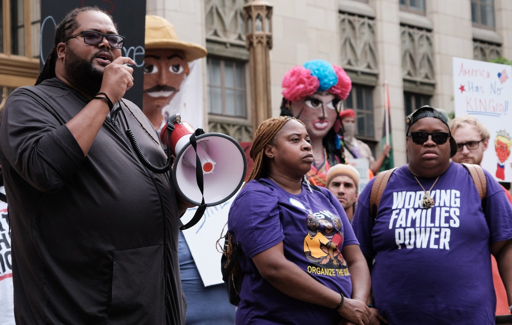 John Taylor, organizer and leading co-founder of Black Male Initiative Georgia, speaks to a crowd of community members outside Atlanta City Hall on May Day to protest the Trump administration policies impacting working people. 